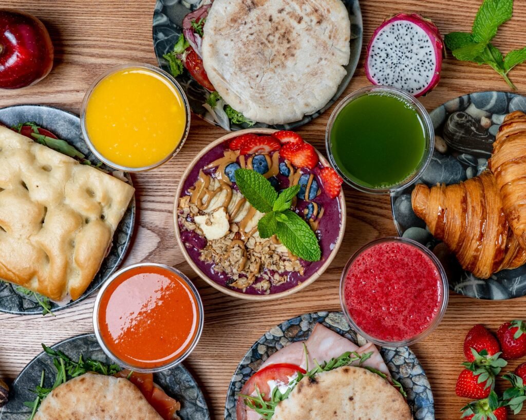Vibrant breakfast spread featuring smoothies, pastries, and fresh fruits. Perfect for a healthy start.